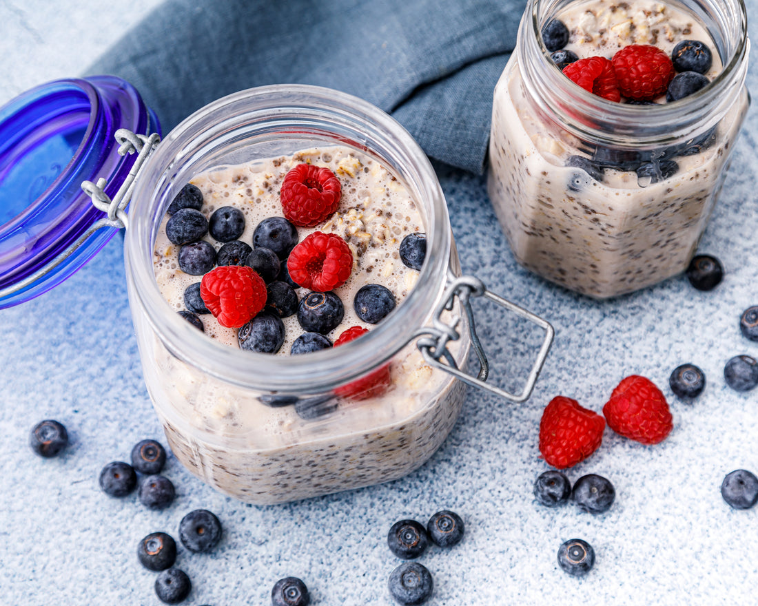 Jars of overnight oats with chia seeds and fresh berries